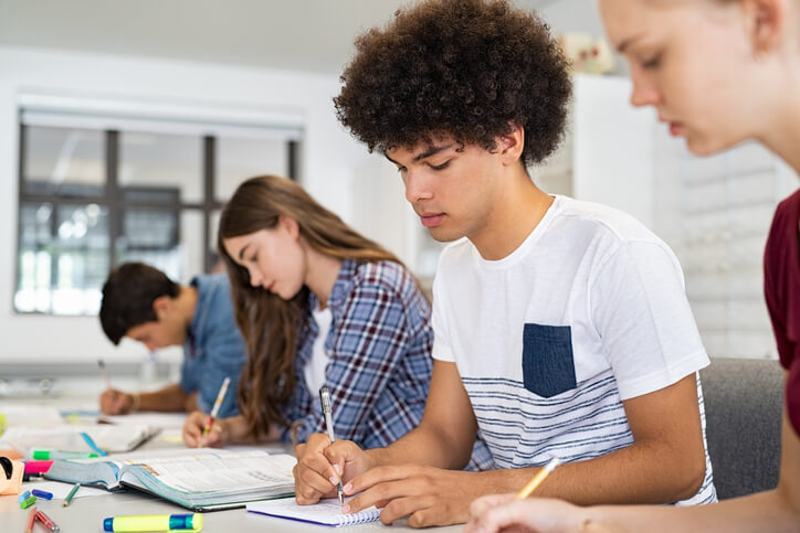 A group of focused students taking notes in class at our private school